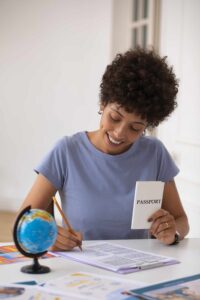 Student holding passport, visa documents, and university acceptance letter.